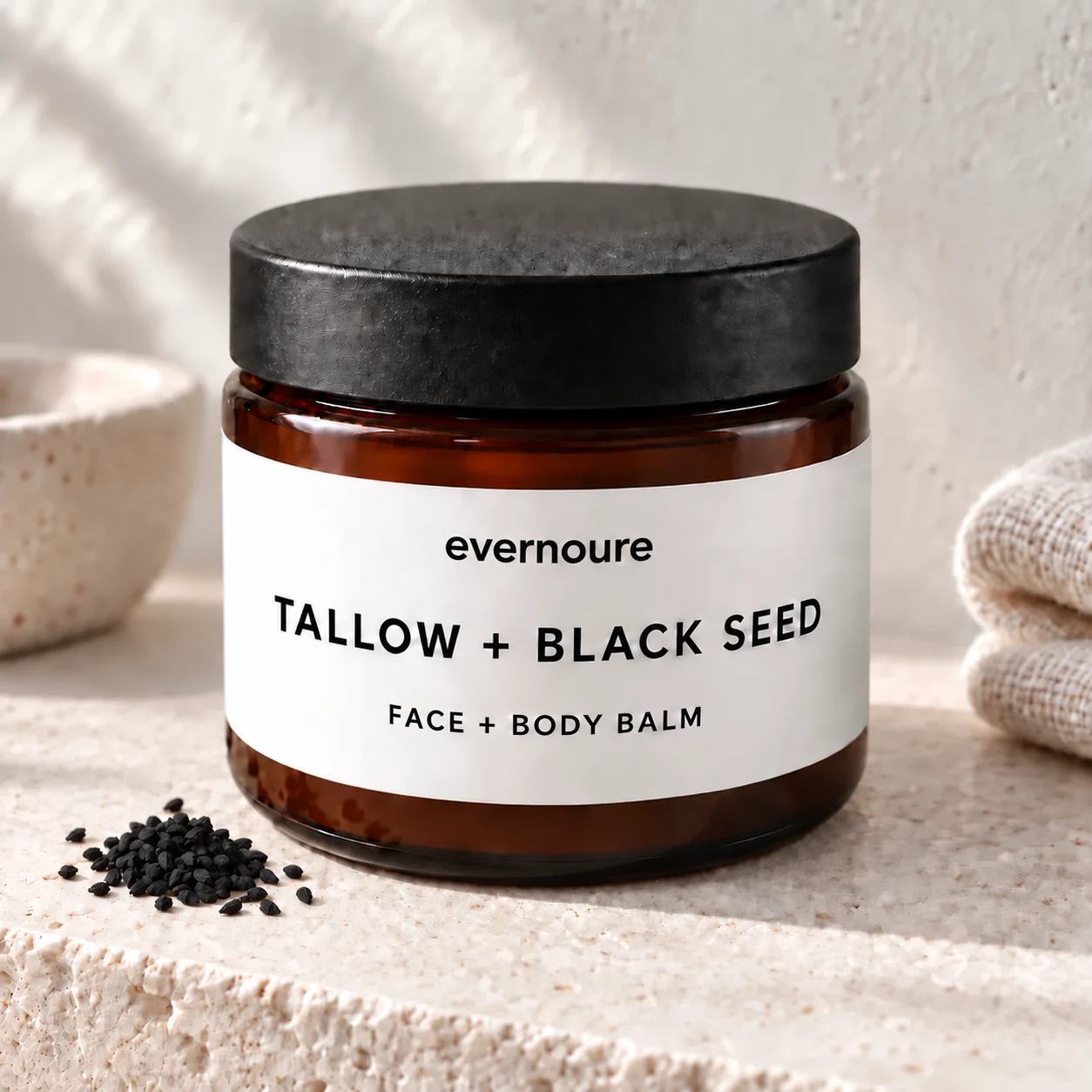 evernoure closed amber jar with black lid and white tallow and black seed balm label